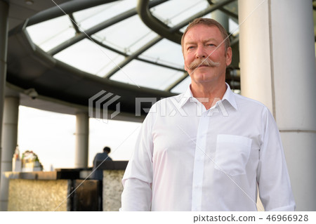 Handsome senior businessman thinking at the rooftop restaurant 46966928