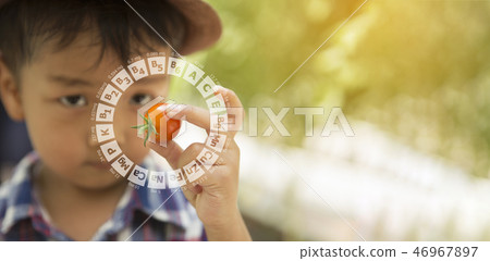 An Asian boy holds a tomato in his hand 46967897