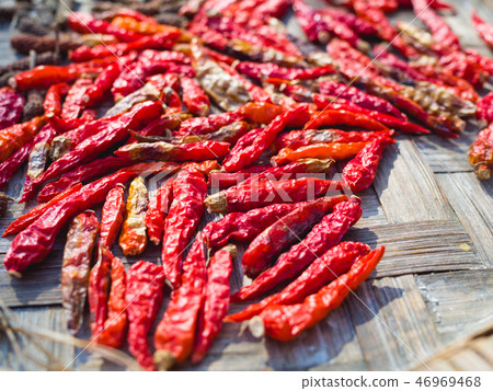 Close up of dried red chilli on baboom tray Close up of dried red chilli on baboom tray 46969468