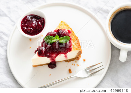 Slice Of Cheesecake With Cherry Sauce And Cup Of Coffee Slice Of Cheesecake With Cherry Sauce And Cup Of Coffee 46969548