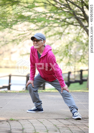 Elderly men who stretch their legs in the park 46969665