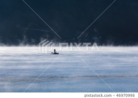 Rippling lake surface and angler Rippling lake surface and angler 46970998