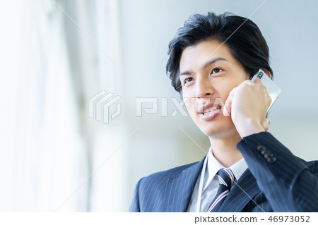 Male employee who calls a young businessman 46973052