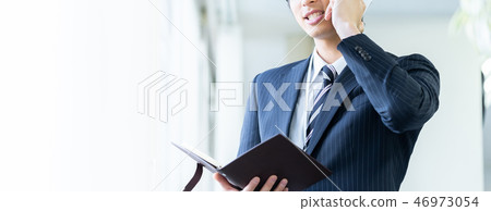 Male employee who calls a young businessman Male employee who calls a young businessman 46973054