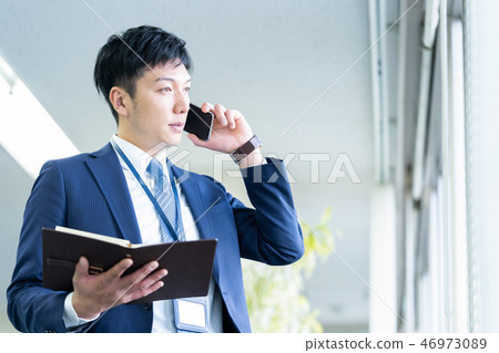 Male employee who calls a young businessman 46973089