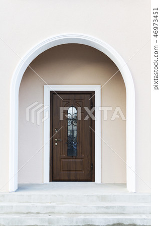 Dark wood front door of a home.  46973451