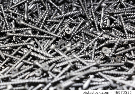 focus on center. black screws texture background focus on center. black screws texture background 46973555