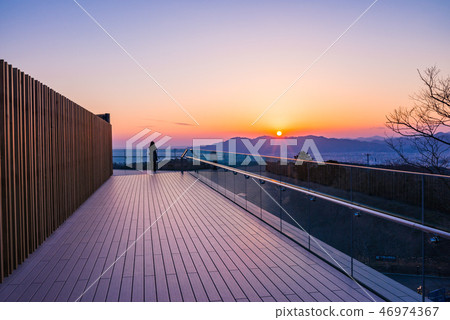 (Shizuoka Prefecture) A woman watching the sunset on Nihon Hiramu Terrace (Shizuoka Prefecture) A woman watching the sunset on Nihon Hiramu Terrace 46974367