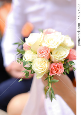 Close up nice bouquet of white and pink roses in bride hands. Close up nice bouquet of white and pink roses in bride hands. 46975988