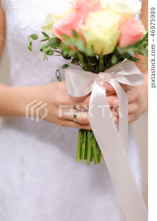 Close up bouquet of white and pink roses in bride hands. Close up bouquet of white and pink roses in bride hands. 46975989