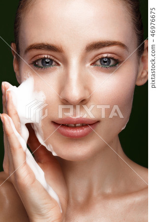 Beautiful young girl with facial wash on the skin. Beauty face. 46976675