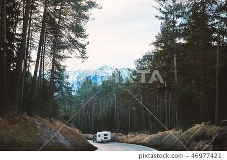 Mystical road in the forest with camper car riding Mystical road in the forest with camper car riding 46977421