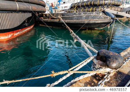 Ships moored in the port with hawsers 46978557