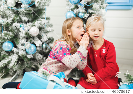 Happy little kids opening presents on Christmas eve 46978617