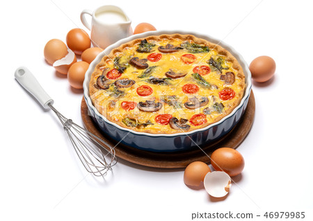 Baked homemade quiche pie in ceramic baking form, eggs and cream 46979985