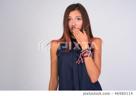 Portrait of young guilty businesswoman covering mouth Portrait of young guilty businesswoman covering mouth 46980114