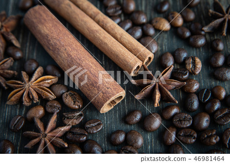 Spicy background. Warm christmas theme. Cinnamon quills, coffee beans and star anise 46981464
