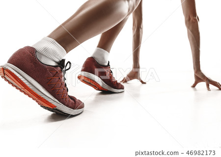 Portrait of young sporty woman at starting block of race isolated over white background Portrait of young sporty woman at starting block of race isolated over white background 46982173