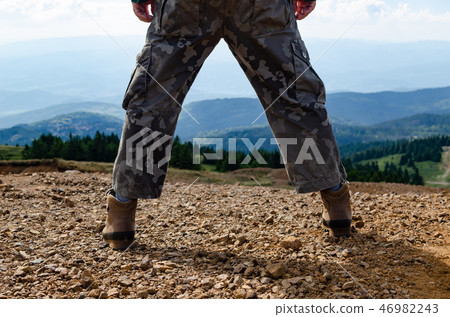 Man on a mountain top 46982243