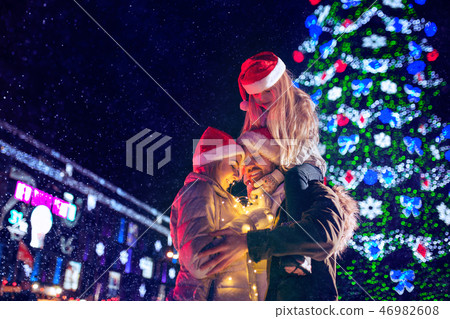 family, christmas, holidays, season and people concept - happy family over city background and snow family, christmas, holidays, season and people concept - happy family over city background and snow 46982608