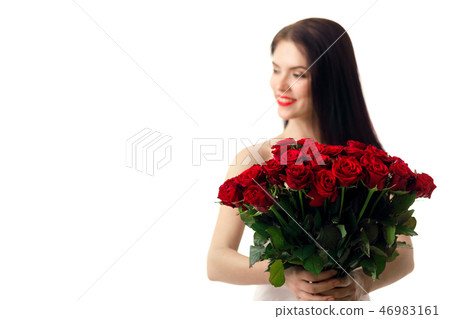 beautiful young woman with a large bouquet of red roses beautiful young woman with a large bouquet of red roses 46983161