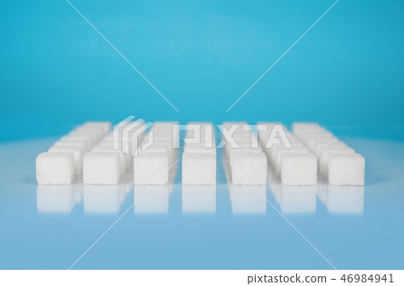 Sugar cubes vary position on light blue background 46984941