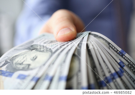 Man in suit and tie hold in arm pack of hundred Man in suit and tie hold in arm pack of hundred 46985082