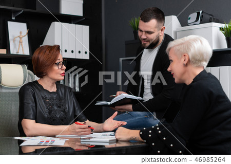 Office workers discuss their project over Cup of tea 46985264
