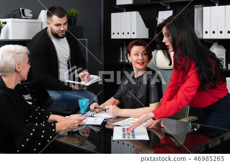 Smiling employees talking in workplace Smiling employees talking in workplace 46985265