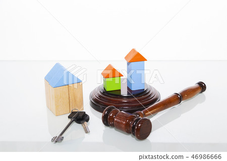 the wooden house and judge gavel on wooden table. 46986666