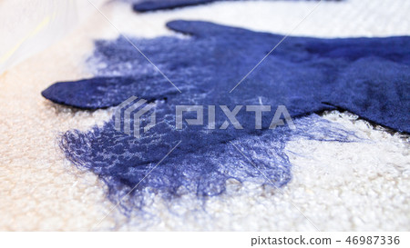 wet felted glove with damped additional fibers 46987336