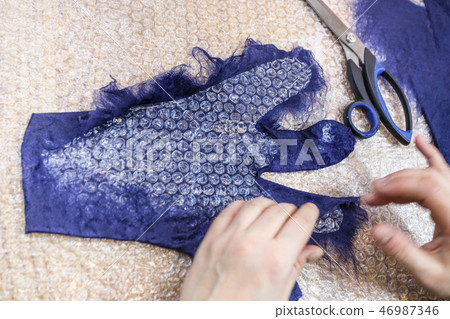 craftsman forming back side of glove with pattern 46987346