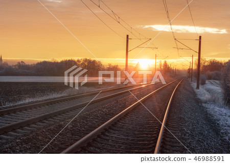 Railroad tracks at sunrise in winter.  46988591