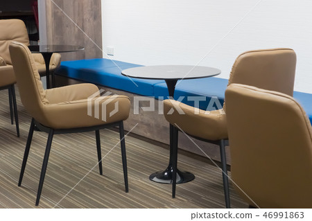 brown chair with glass table in co working space. 46991863