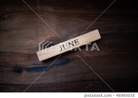A small wooden item written with JUNE A small wooden item written with JUNE 46993038