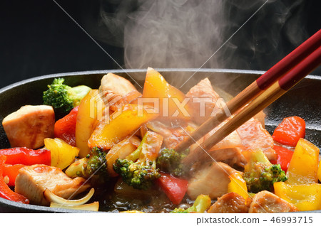 Stir fry of chicken during cooking 46993715