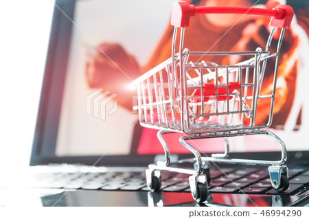 online shopping. Shopping cart trolley on laptop online shopping. Shopping cart trolley on laptop 46994290