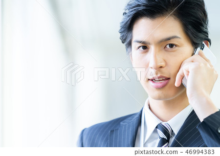 Male employee who calls a young businessman Male employee who calls a young businessman 46994383
