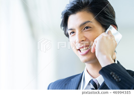 Male employee who calls a young businessman Male employee who calls a young businessman 46994385