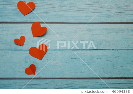 Red paper hearts on a blue wooden background Red paper hearts on a blue wooden background 46994388