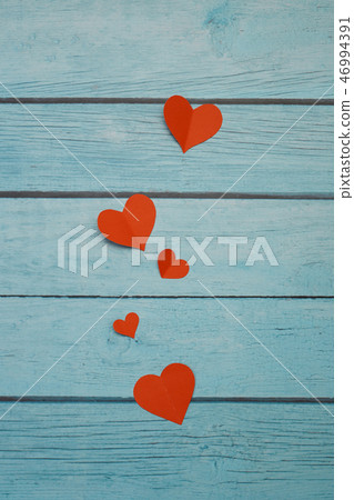Red paper hearts on a blue wooden background Red paper hearts on a blue wooden background 46994391