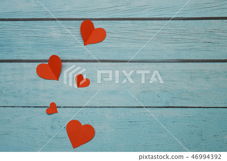 Red paper hearts on a blue wooden background Red paper hearts on a blue wooden background 46994392