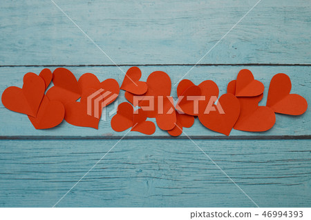 Red paper hearts on a blue wooden background Red paper hearts on a blue wooden background 46994393