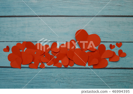 Red paper hearts on a blue wooden background Red paper hearts on a blue wooden background 46994395