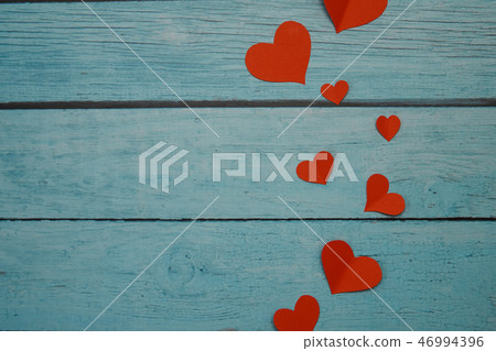 Red paper hearts on a blue wooden background Red paper hearts on a blue wooden background 46994396