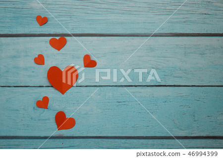 Red paper hearts on a blue wooden background Red paper hearts on a blue wooden background 46994399