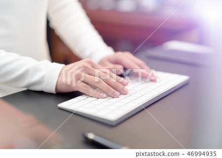 financial advisor typing on keyboard at office financial advisor typing on keyboard at office 46994935