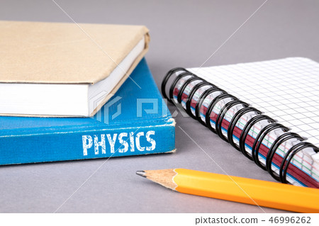 physics concept. blue book on a gray office table physics concept. blue book on a gray office table 46996262