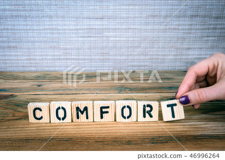 comfort. Wooden letters on the office desk comfort. Wooden letters on the office desk 46996264