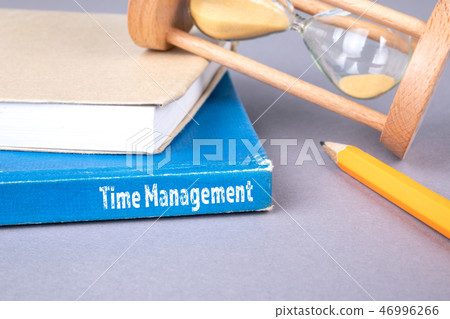 time management concept. blue book on a gray office table time management concept. blue book on a gray office table 46996266